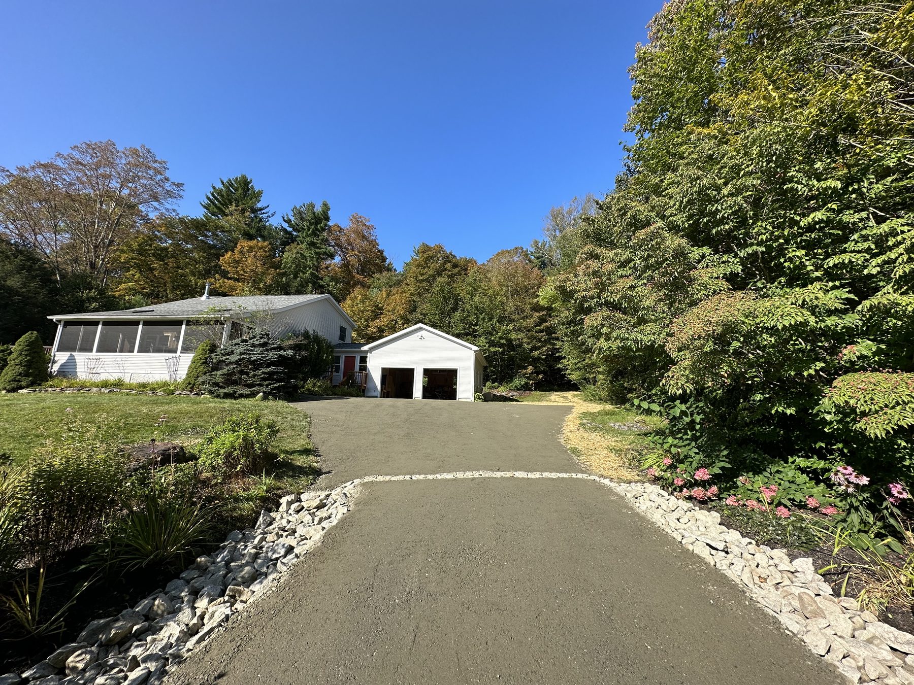 New asphalt driveway with stone edging