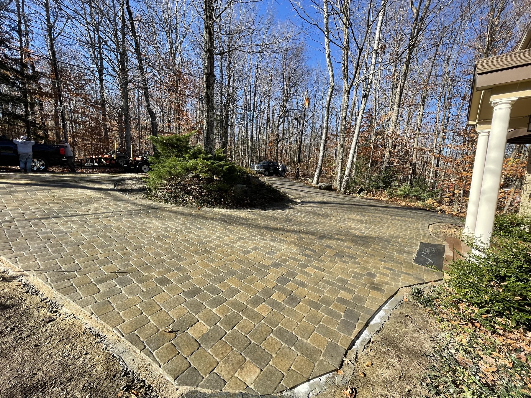 Cobblestone paver driveway apron at a home entry
