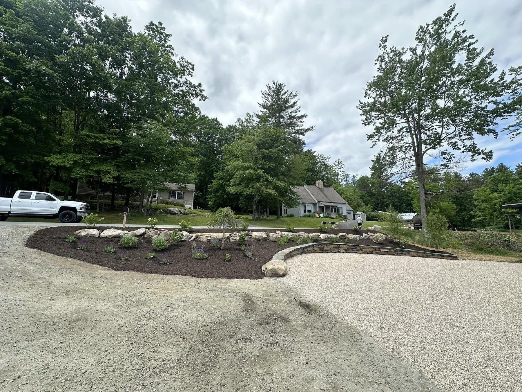Gravel drive with a new boulder-edged planting bed