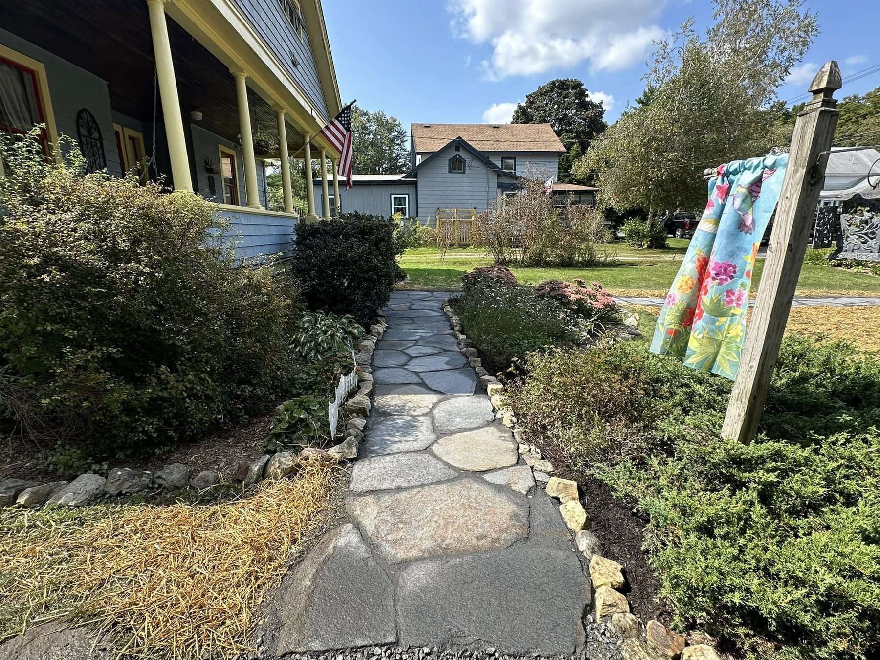 Fieldstone walkway bordered by plantings