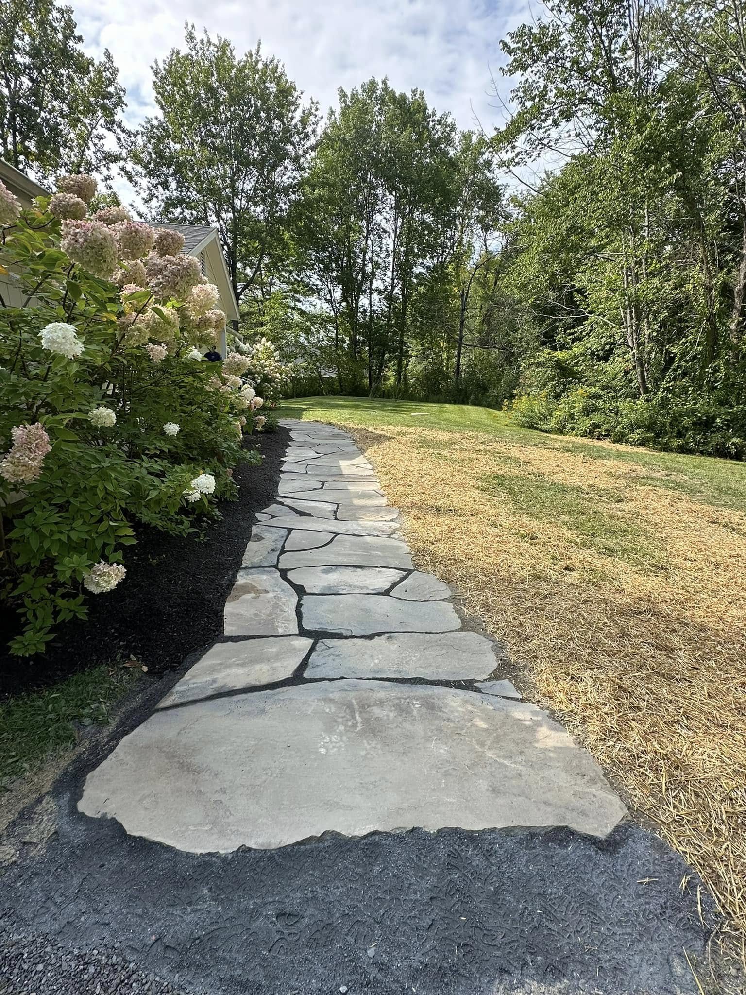 Natural stone walkway set through a lawn