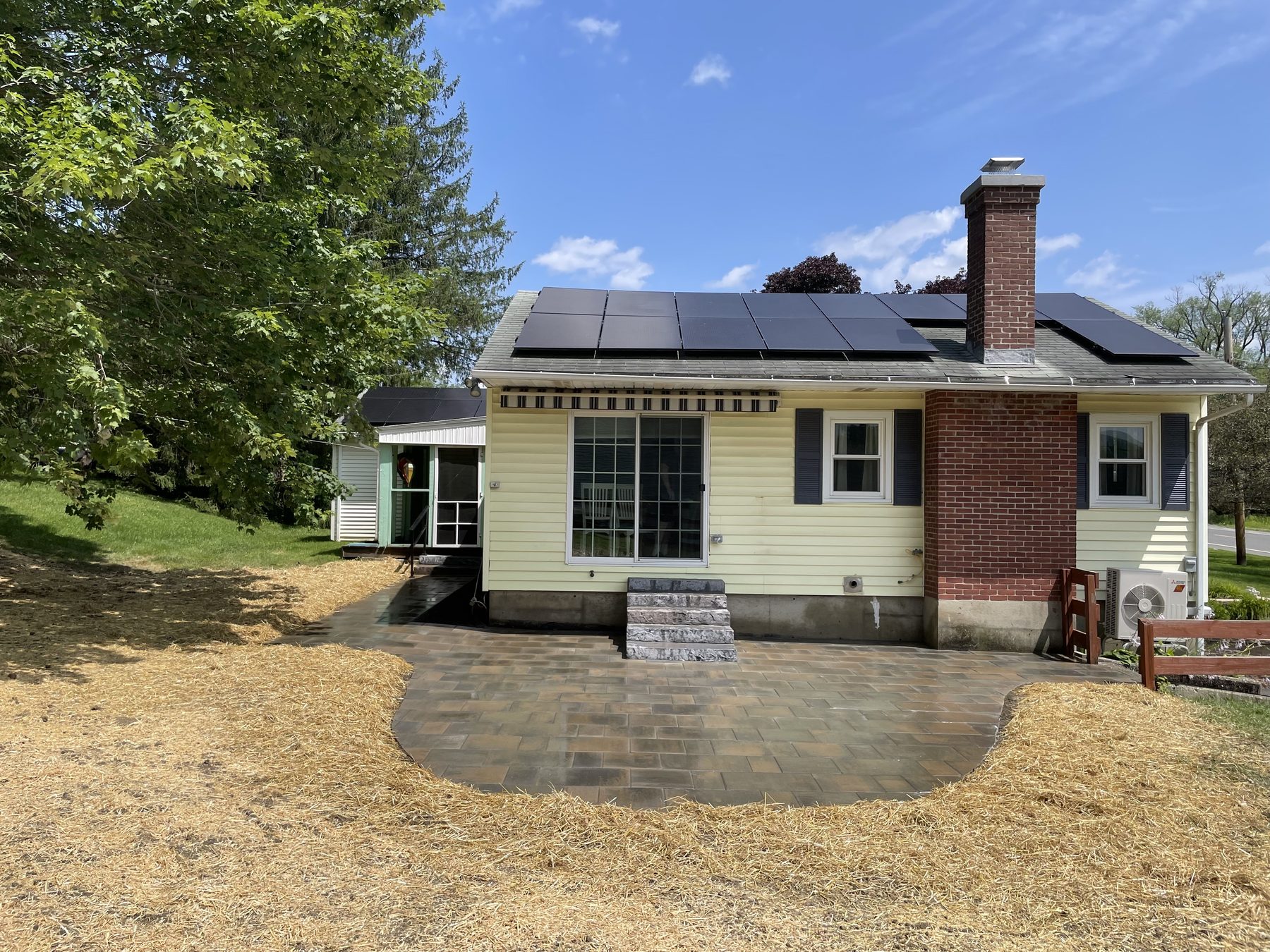 Paver patio laid behind a cottage