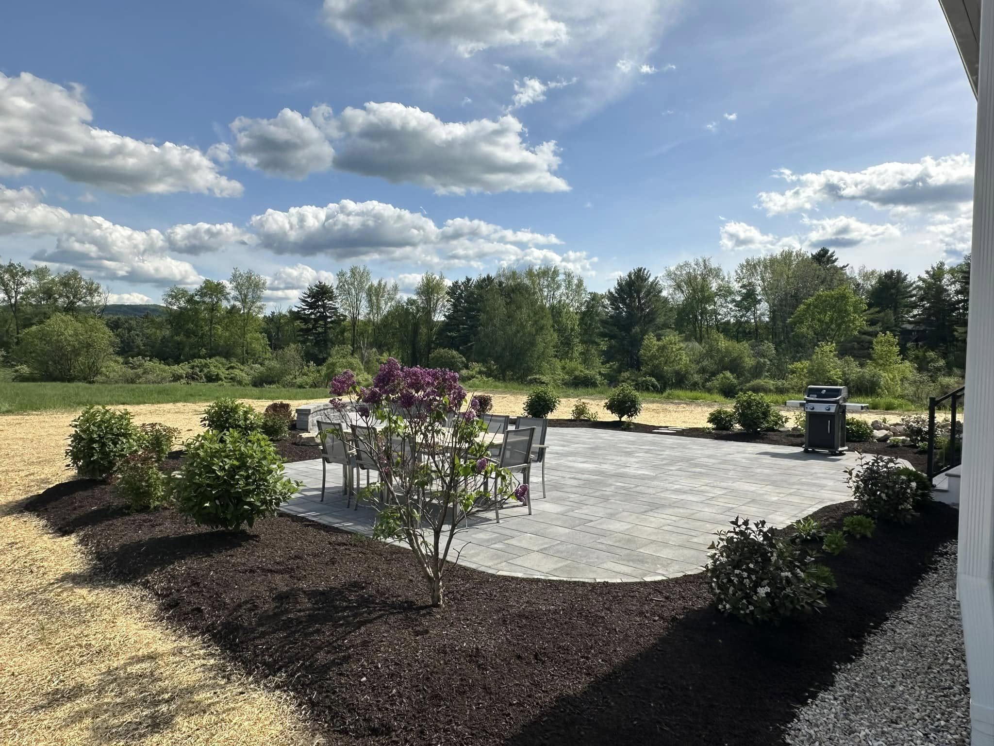 Large paver patio with new plantings overlooking open Berkshire County fields, built by Nathan T Buratto Landscaping