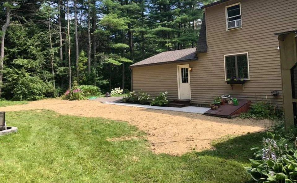 Lawn repair and seeding beside a house