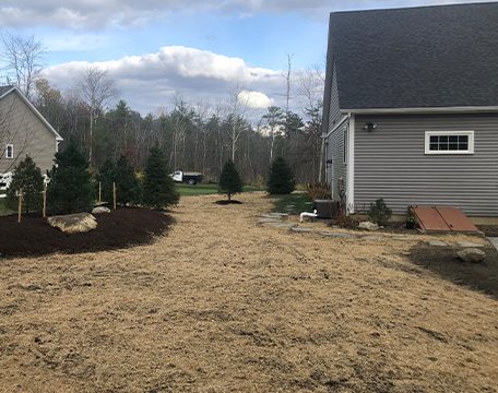 New beds and seeded lawn at a newly built home