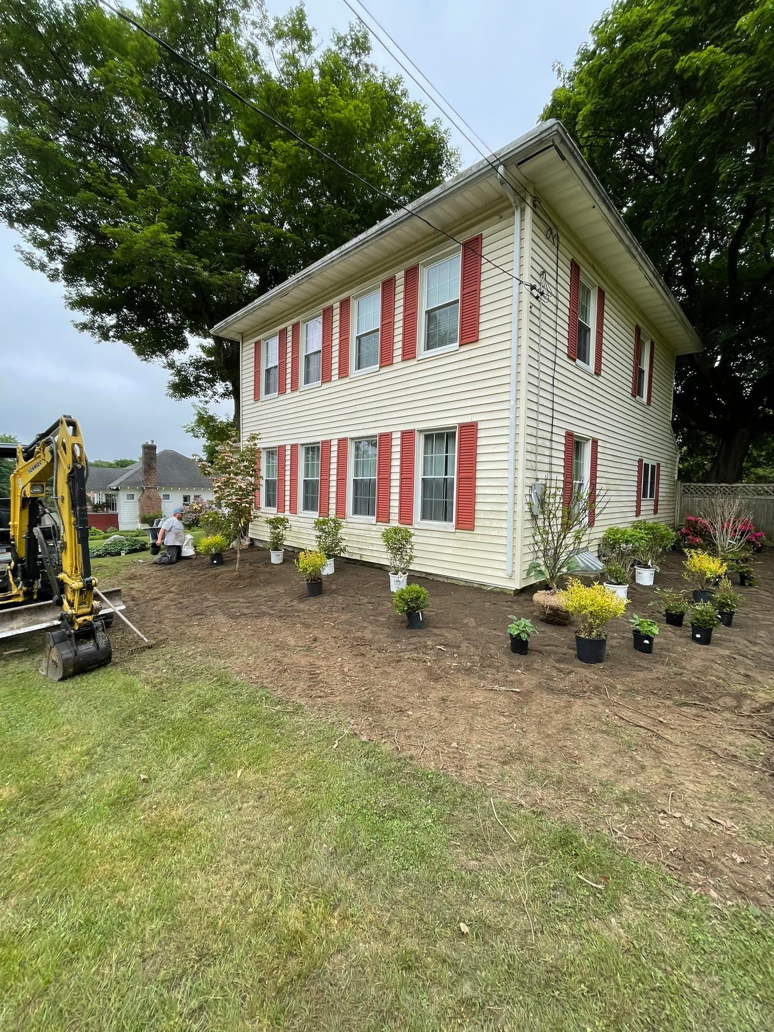 Planting prep and bed shaping at the front of a house