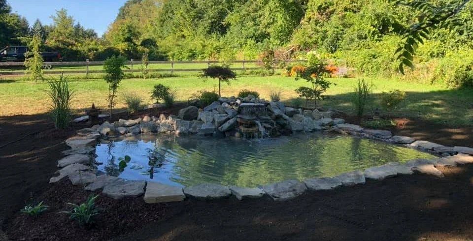 Finished koi pond with a stone waterfall feature